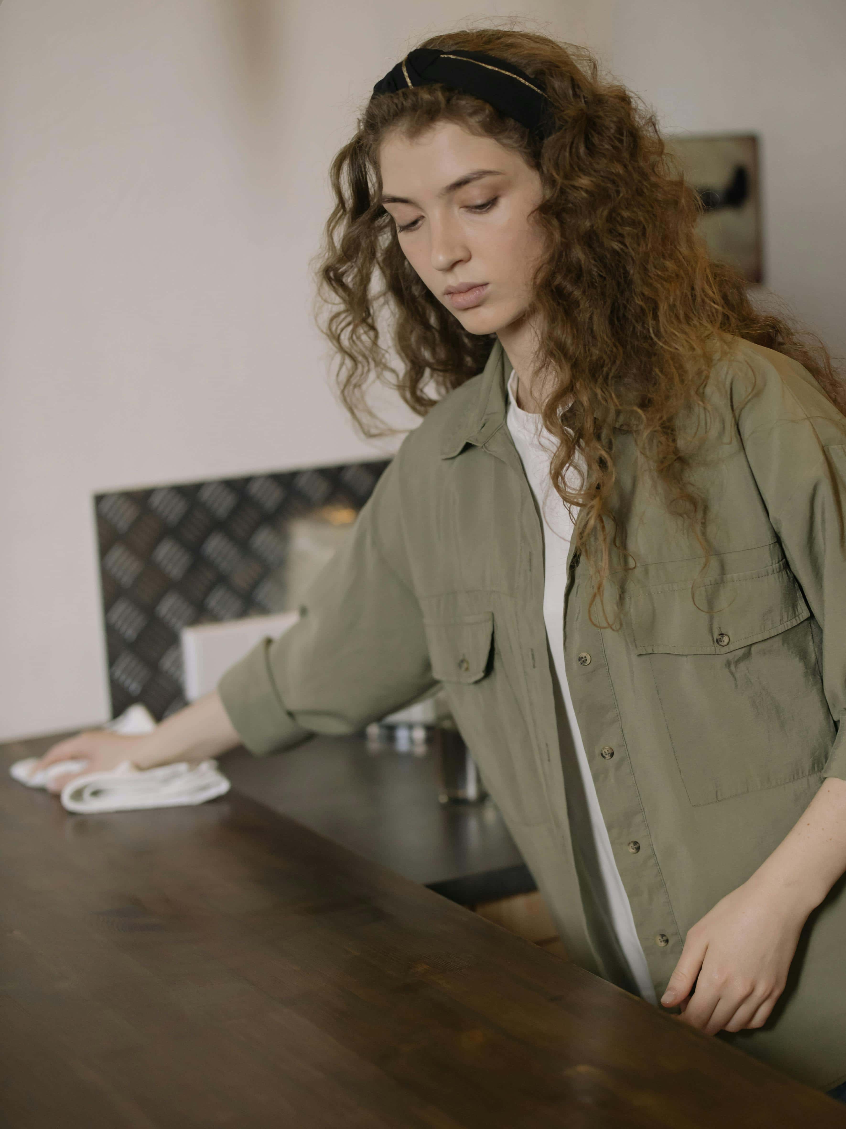 Professional cleaner wiping down surfaces for Airbnb turnover