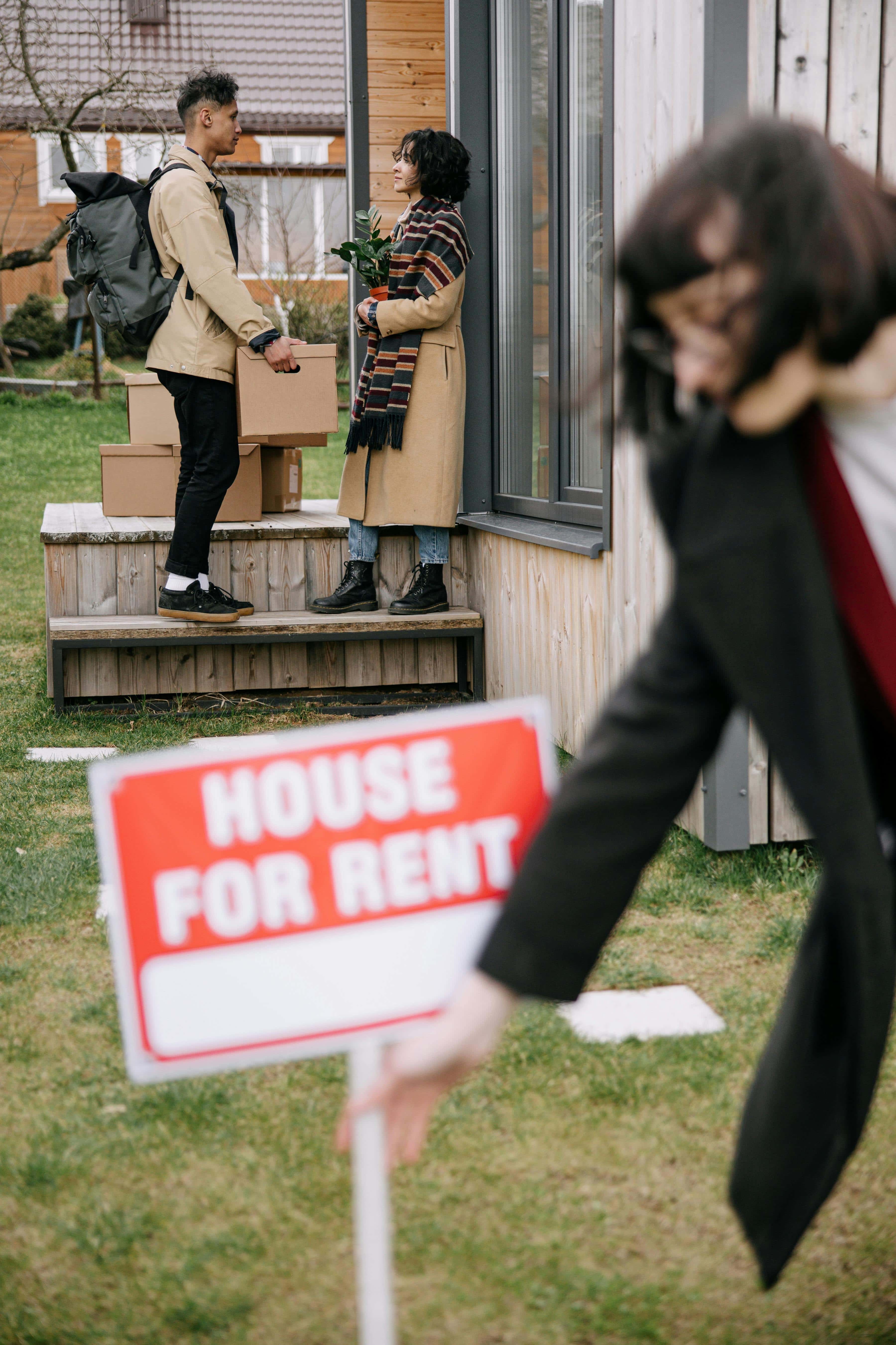 Tenants moving out with House for Rent sign